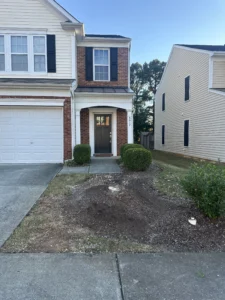 The front of a townhome in North Raleigh, NC, is shown after North Raleigh Tree removed the maple tree and cleared all debris, leaving a tidy and open space.